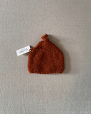 Knitted by Nana Top Knot Beanie - Rust